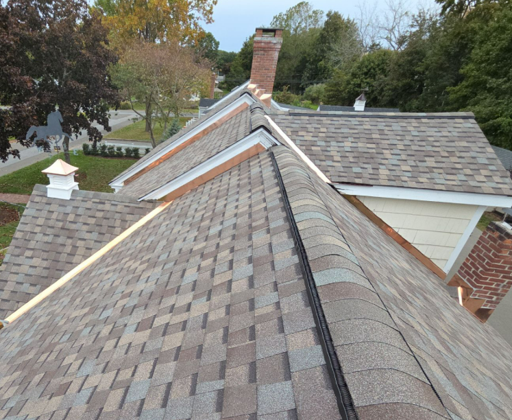 Copper roof-to-wall transitions on a completed shingle roof